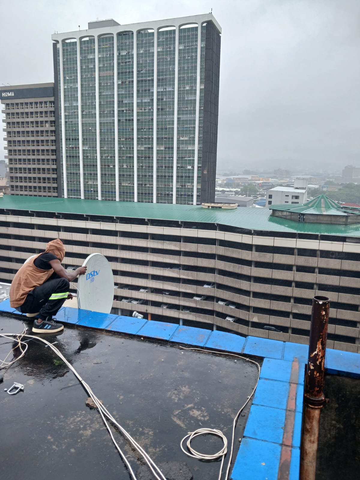 Elite DSTV Installers technician aligning a satellite dish on a Durban rooftop